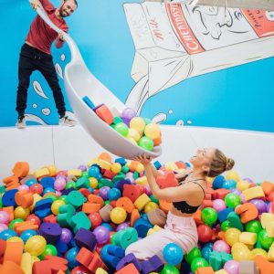 Couple playing in ball pit at Cheat Day Land
